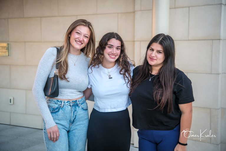 Three students smiling together at a Chabad MU gathering